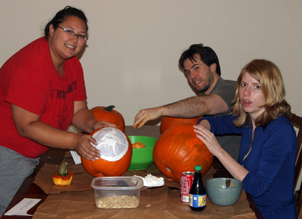 Roommates carving pumpkins for Halloween